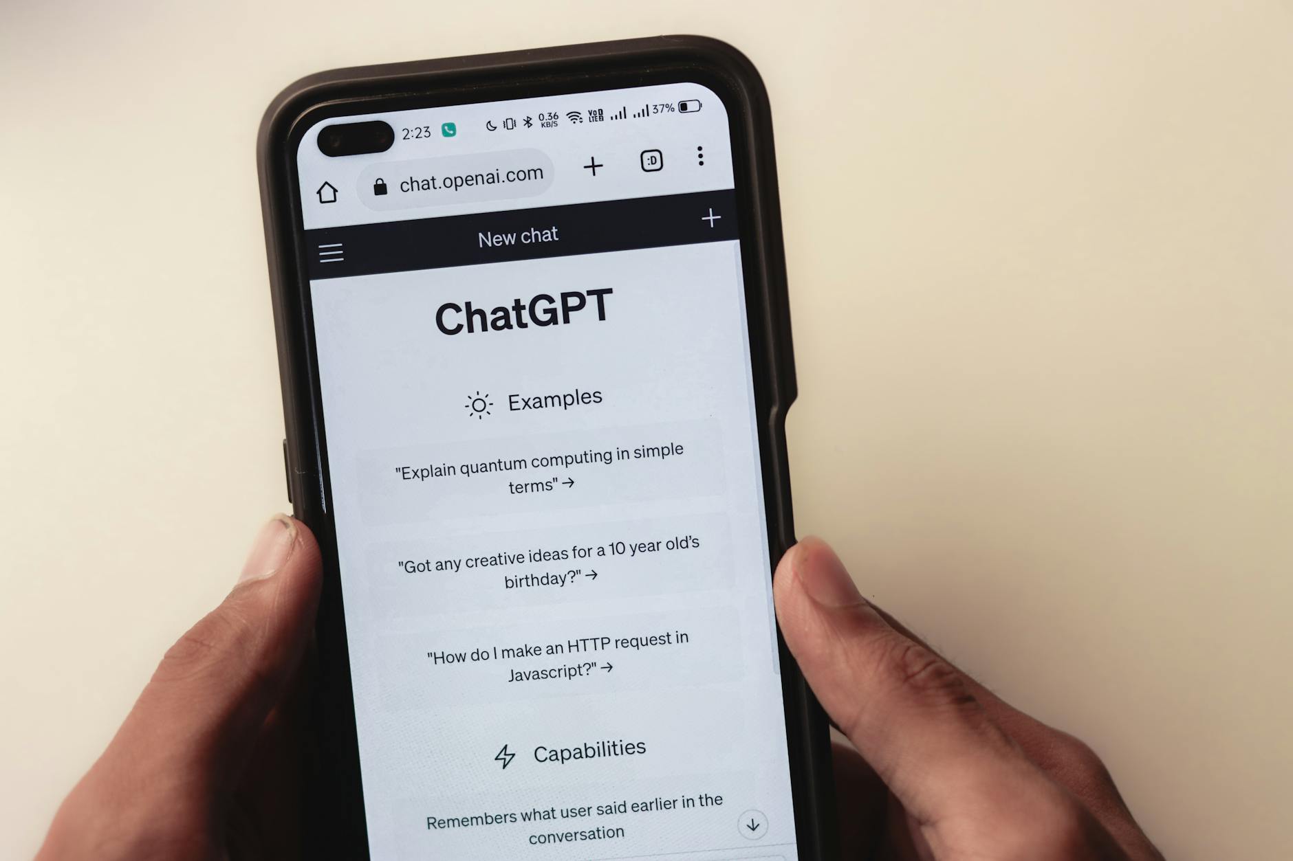 Person holding phone with ChatGPT open representing a 30 day comparison test between ChatGPT and Claude AI tools