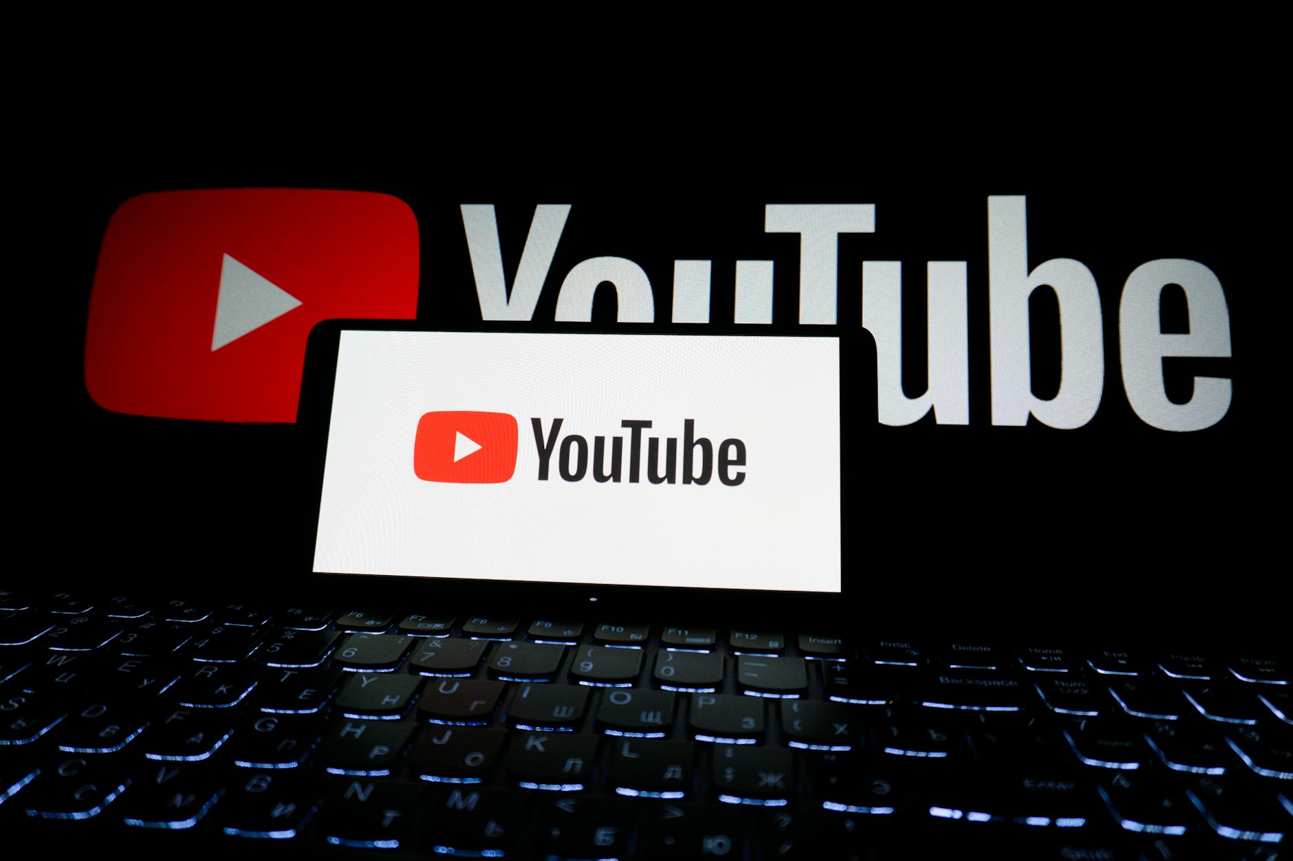 YouTube logo on a keyboard representing AI video creation and monetization on YouTube in 2026